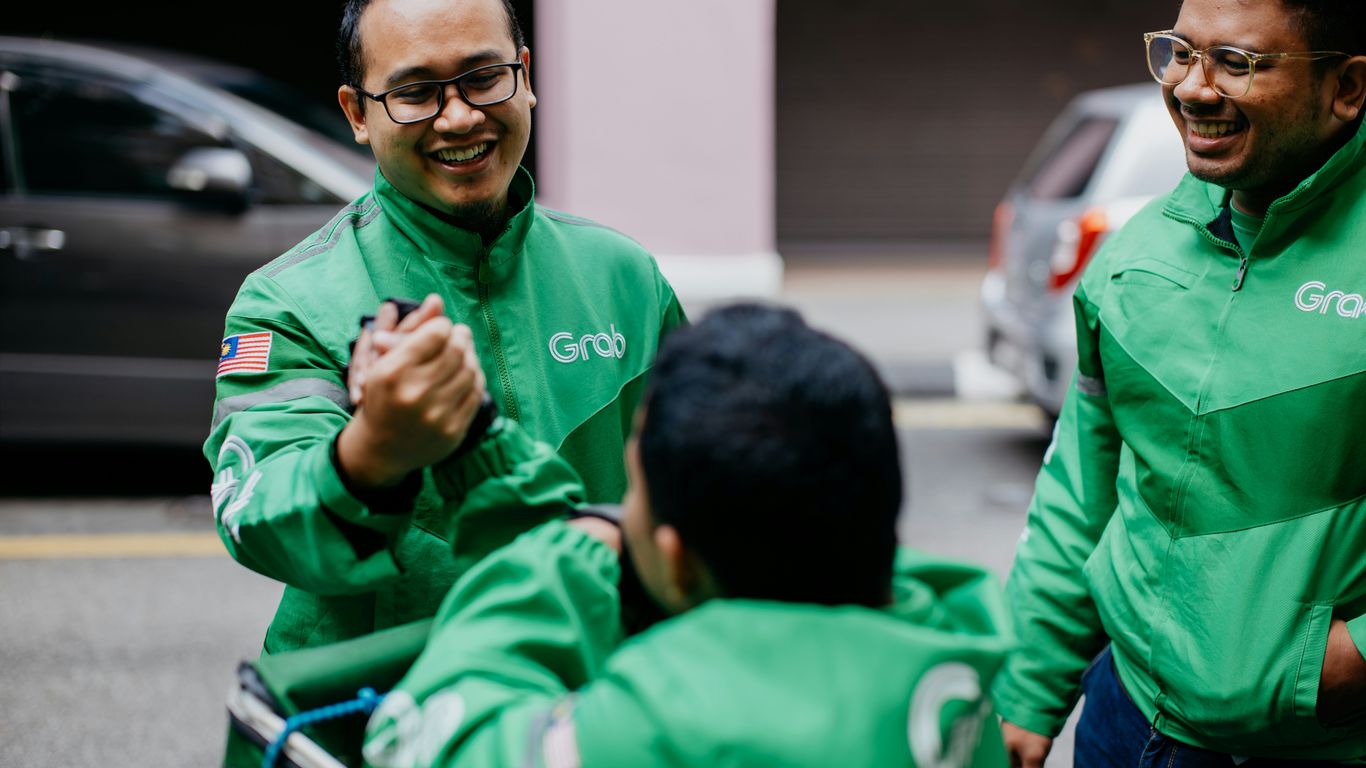 a group of men in green jackets standing next to each other