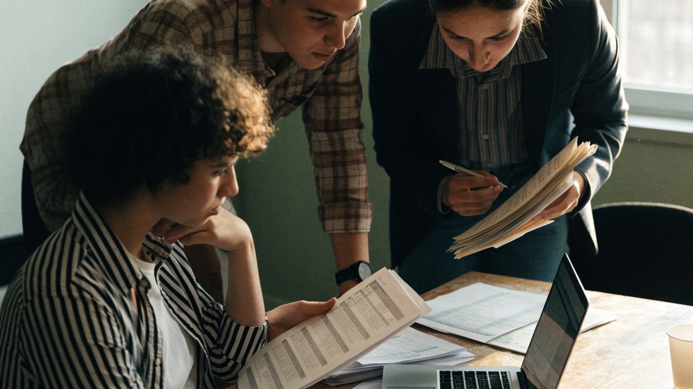 Finance team reviewing transaction records at month-end