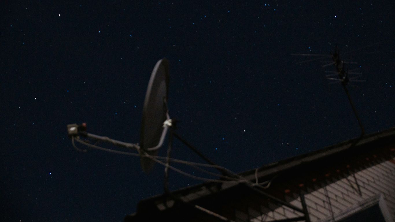 A satellite dish sitting on top of a roof