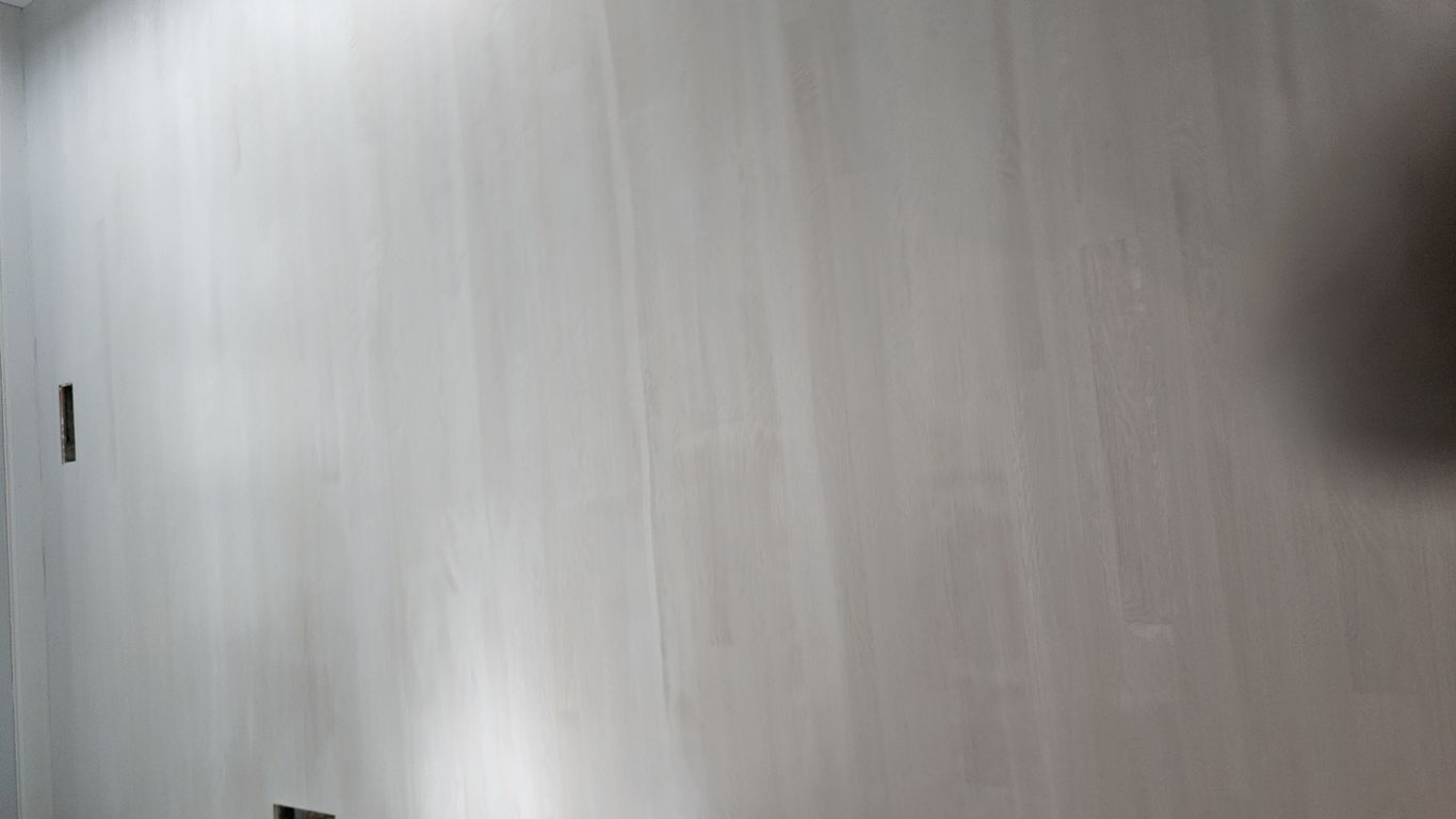 The image shows a smooth, light-colored wooden floor.