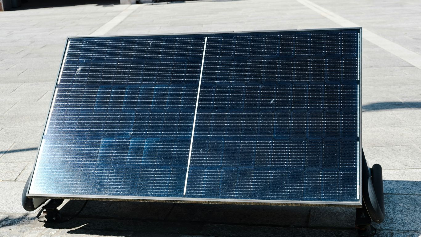 Solar panel angled on a stone surface.