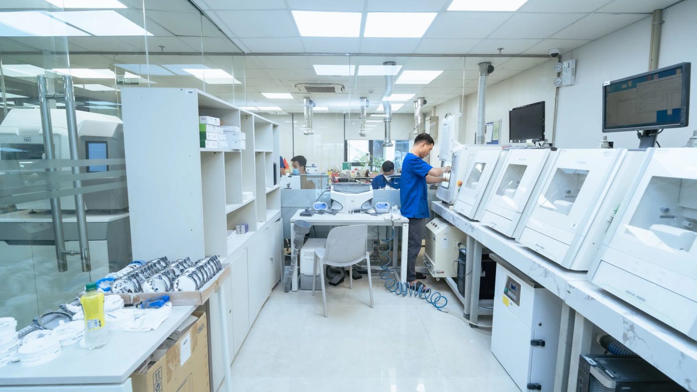 Dental laboratory with technicians working on advanced equipment.