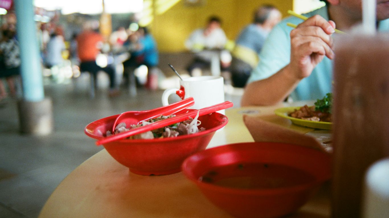 Colourful hawker dishes arranged on table