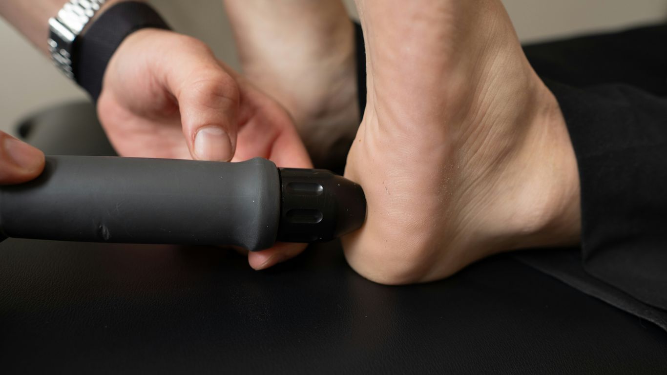 Close-up of a person receiving treatment on their heel.