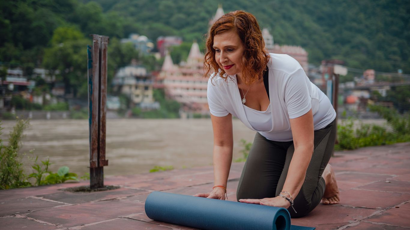 a woman is doing yoga on the ground