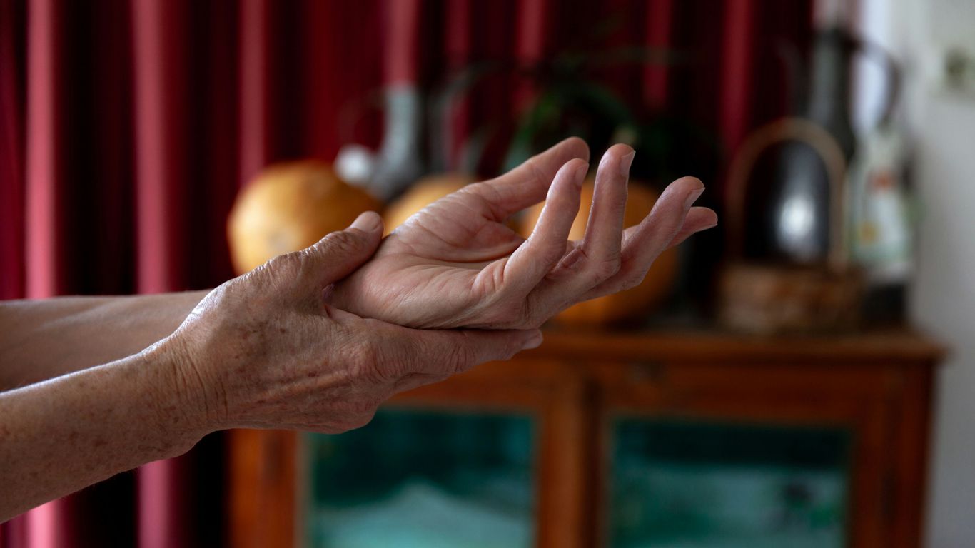 A woman holding out her hands in a living room