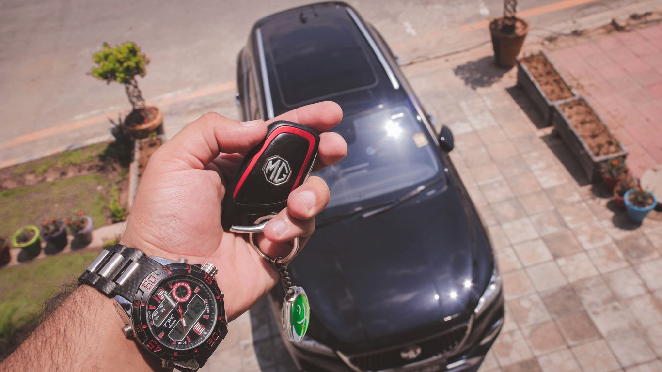 Driver checking car keys beside vehicle