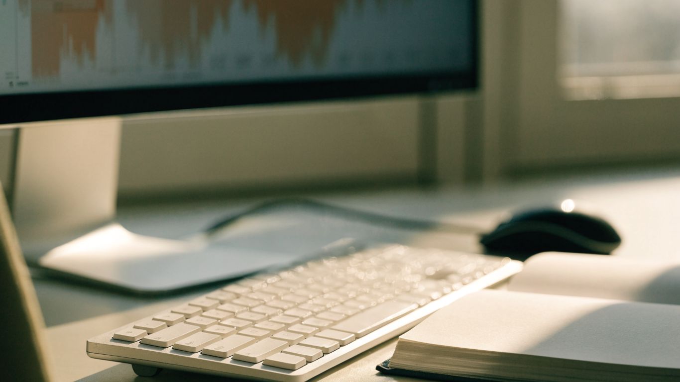 Photographic view of an uncluttered trading workstation with charts