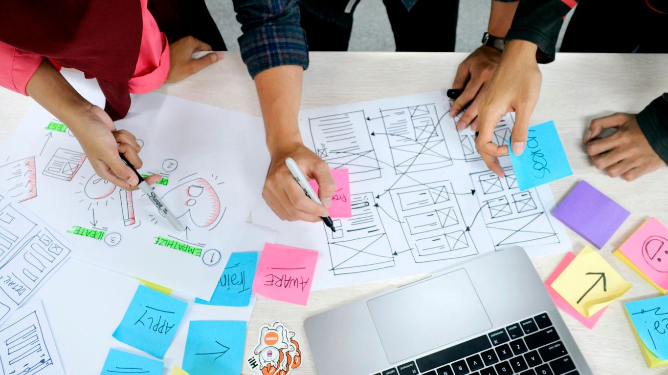 A diverse professional team reviewing creative design prototypes