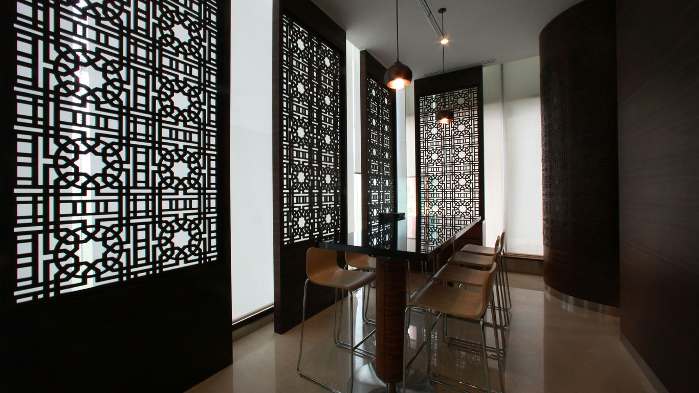 Modern office space with patterned dividers and seating.