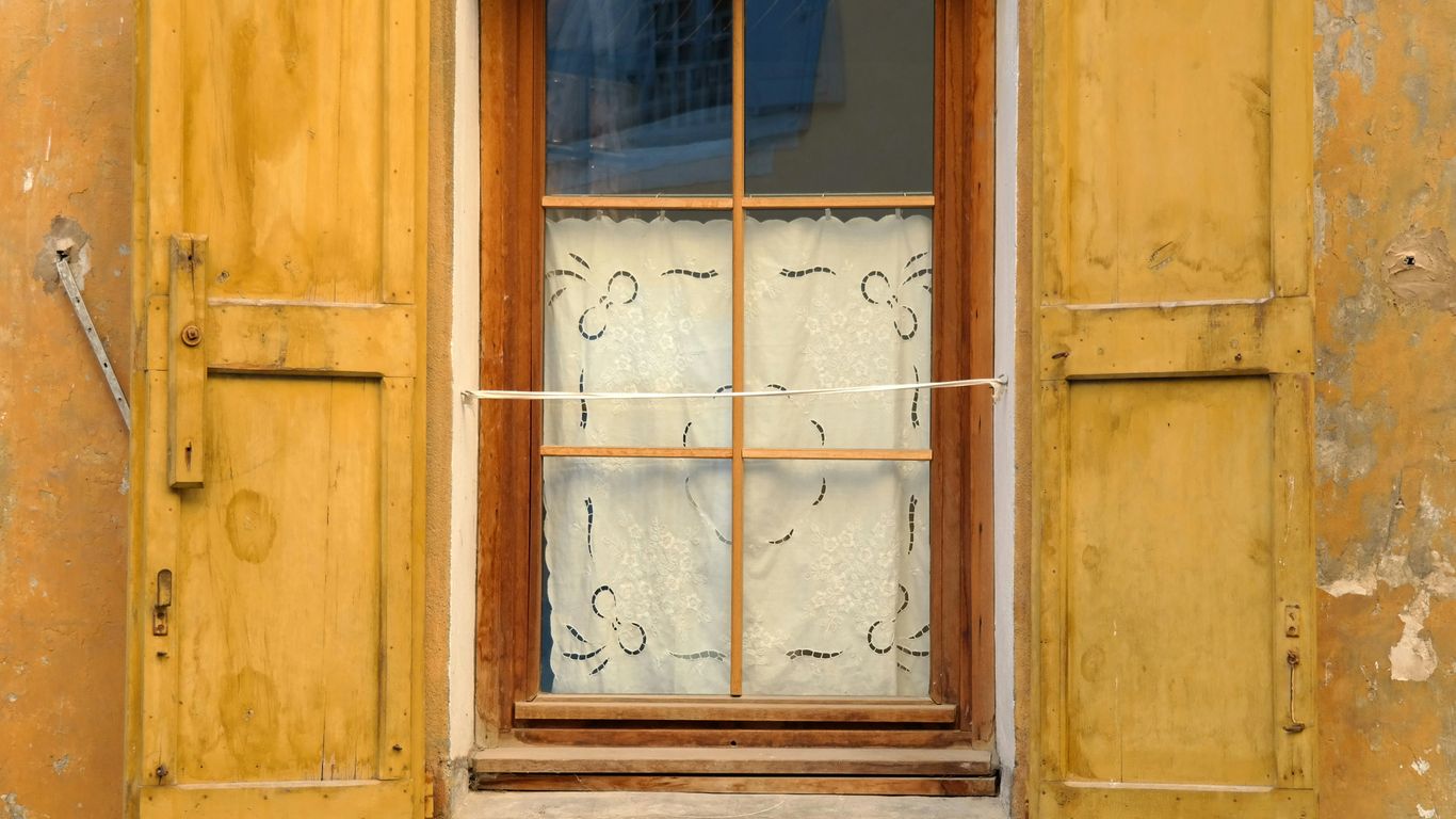 Timber shutters and tall shophouse windows
