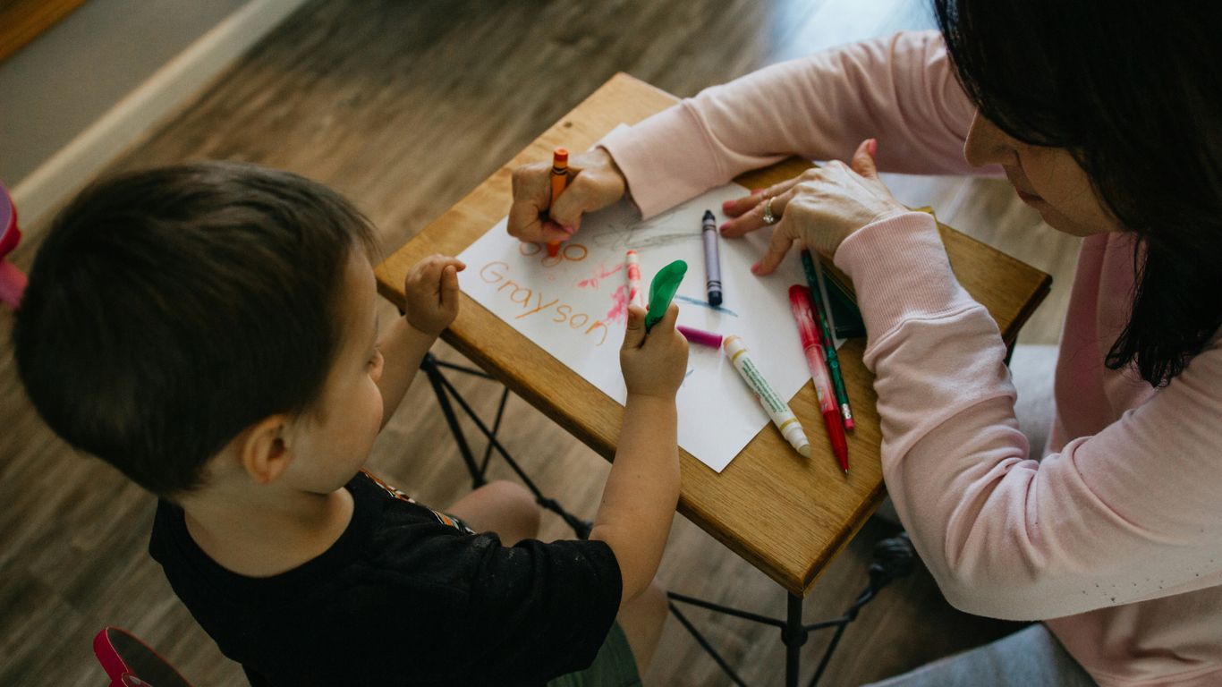 Teacher helping toddler name feelings
