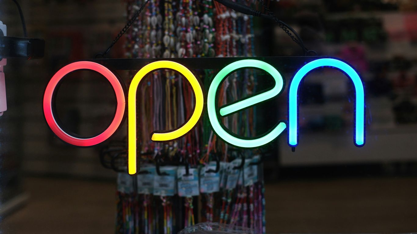Vertical sign holder on a retail counter