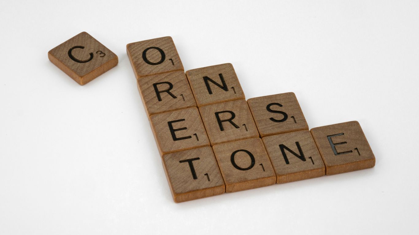scrabble tiles spelling the word correrstone on a white background