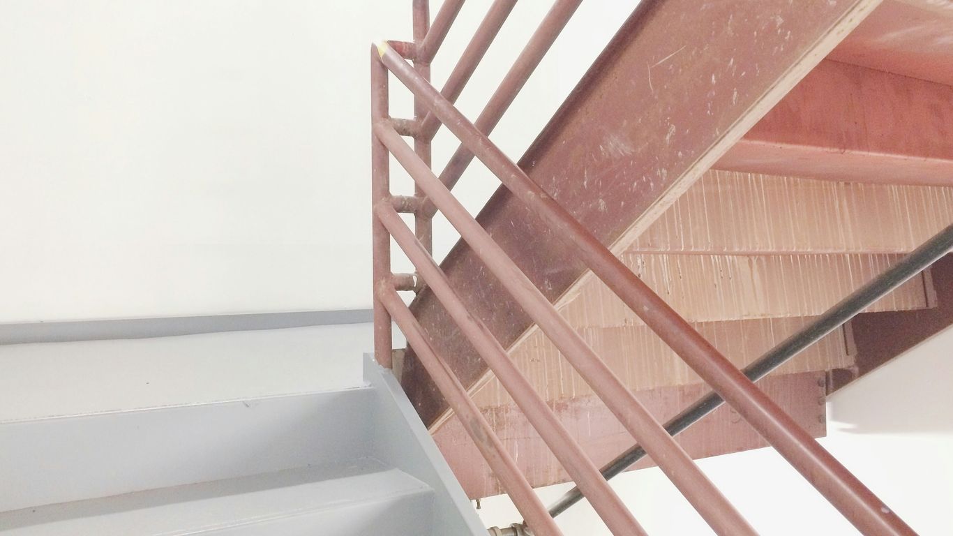 brown and white staircase with railing