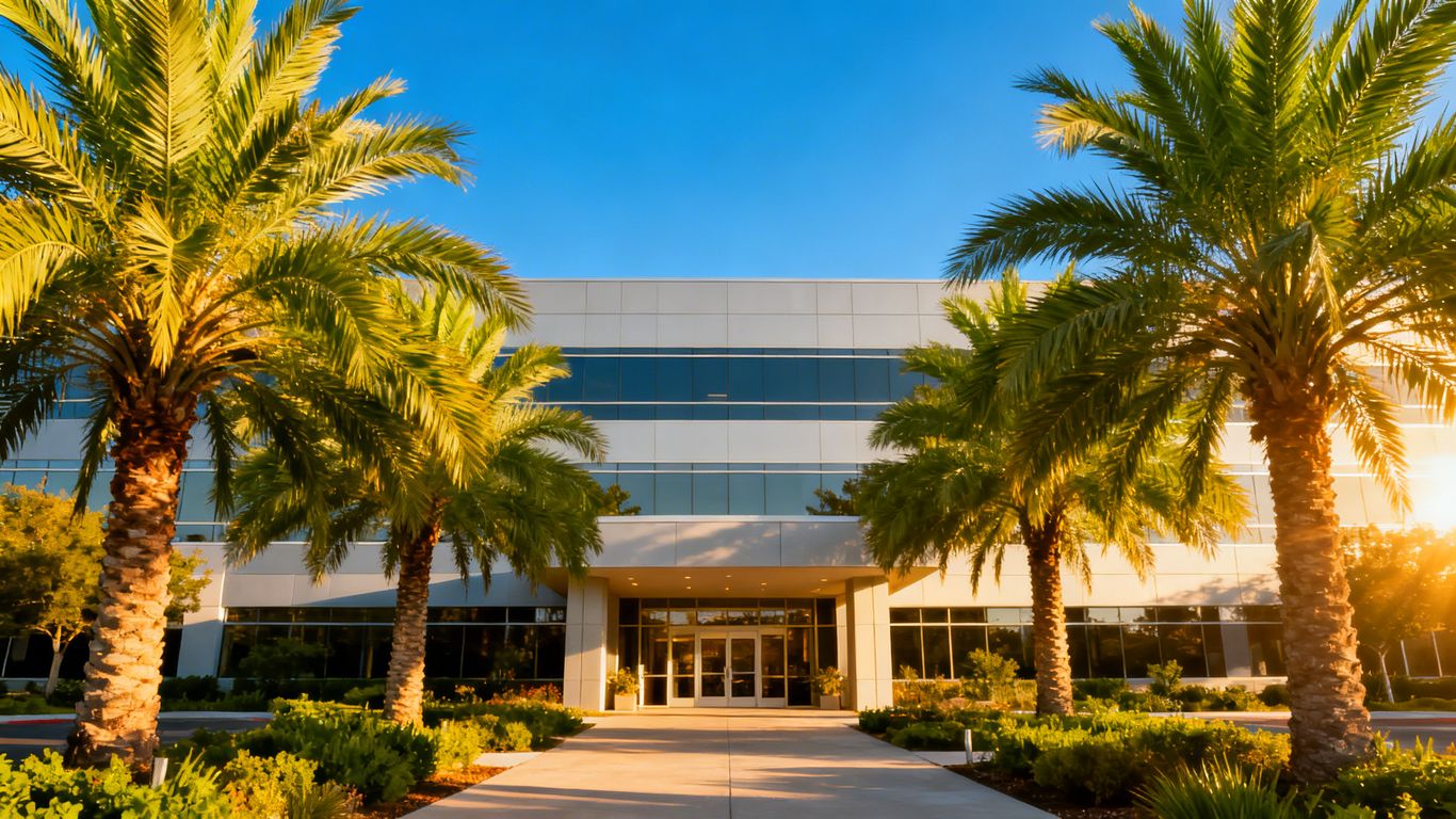 Modern office building with palm trees in Fort Myers.