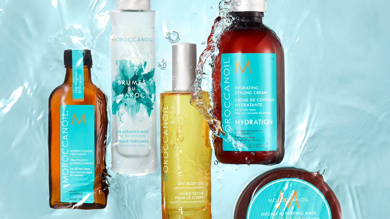 Bottles of hair care products floating in water, dynamic splash.