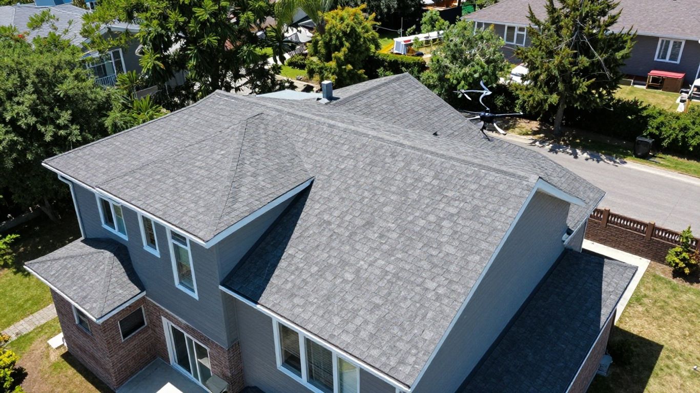 Drone measuring a residential rooftop on a sunny day.