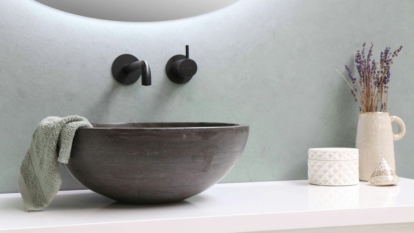 Carved stone basin in calm bathroom