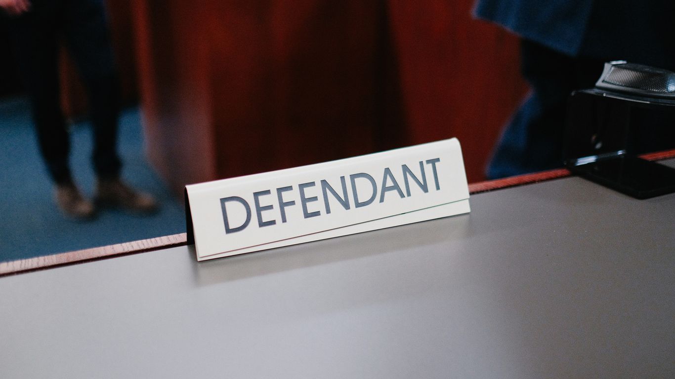 a desk with a sign on it that says defend
