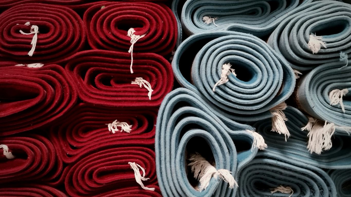 a pile of rolled up rugs sitting next to each other