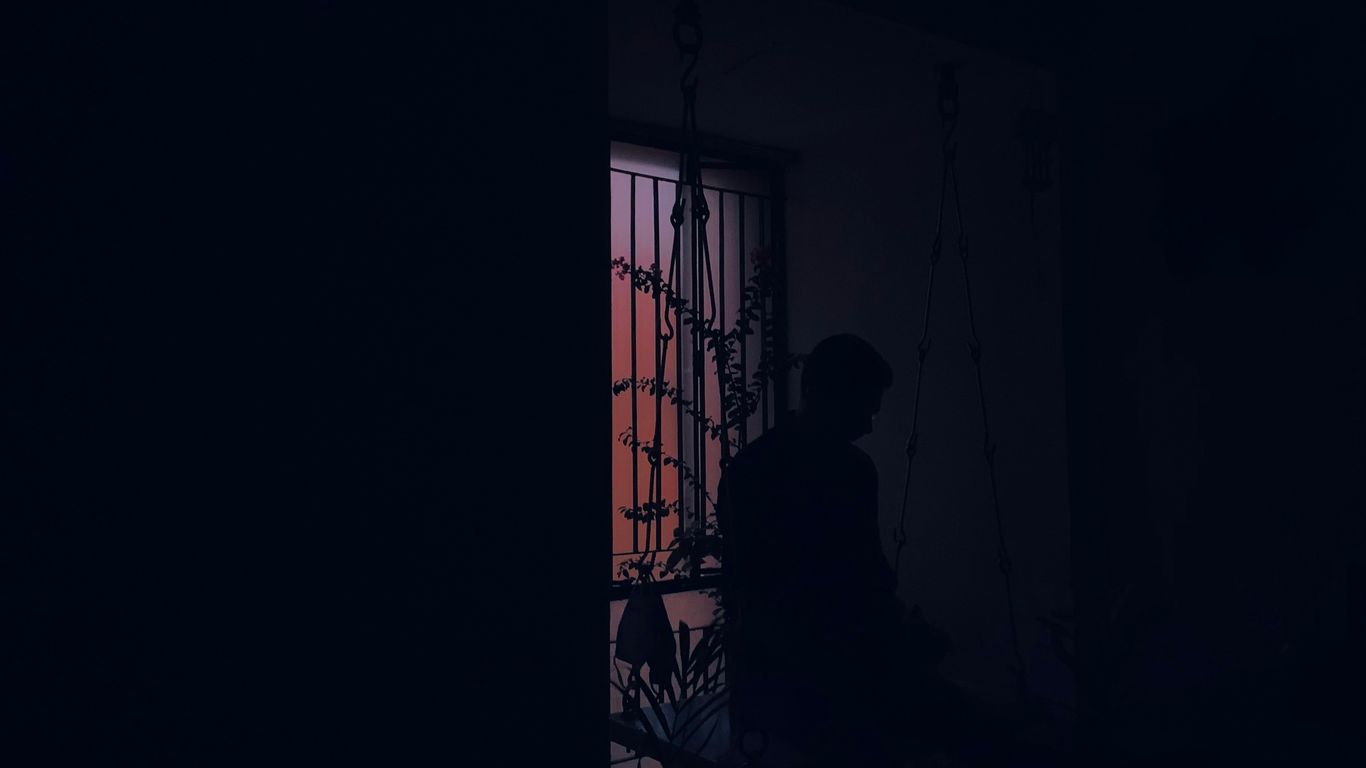 silhouette of person standing near window