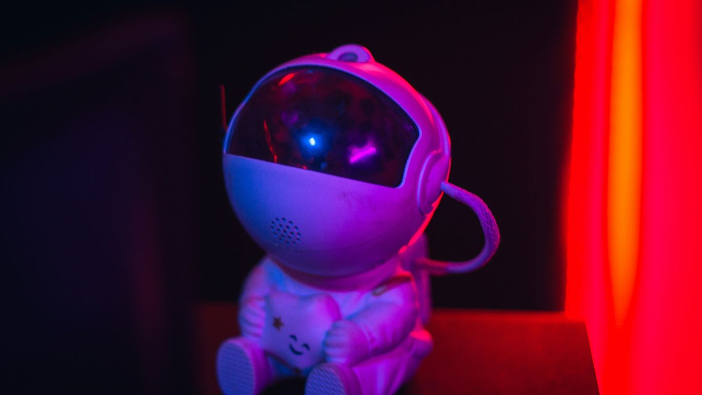 A small astronaut toy with a glowing blue light.