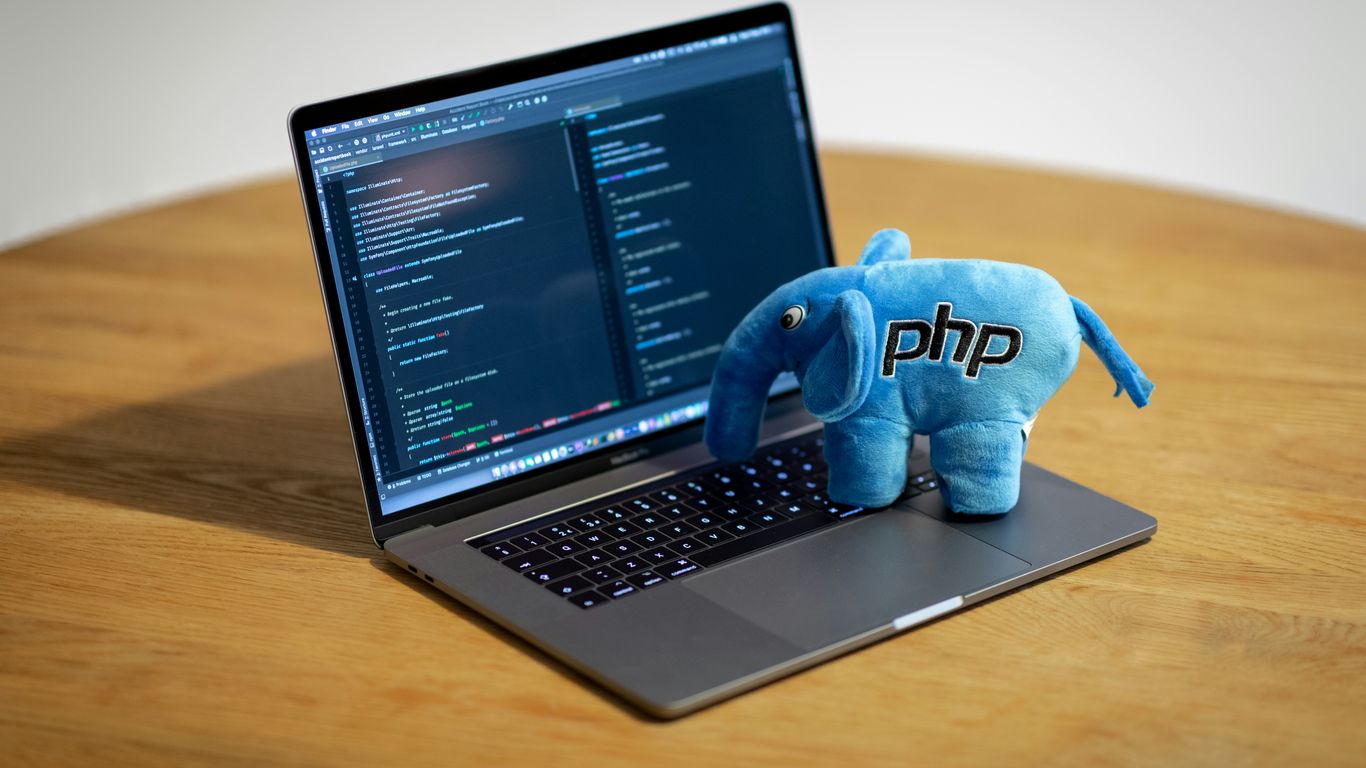 blue elephant figurine on macbook pro
