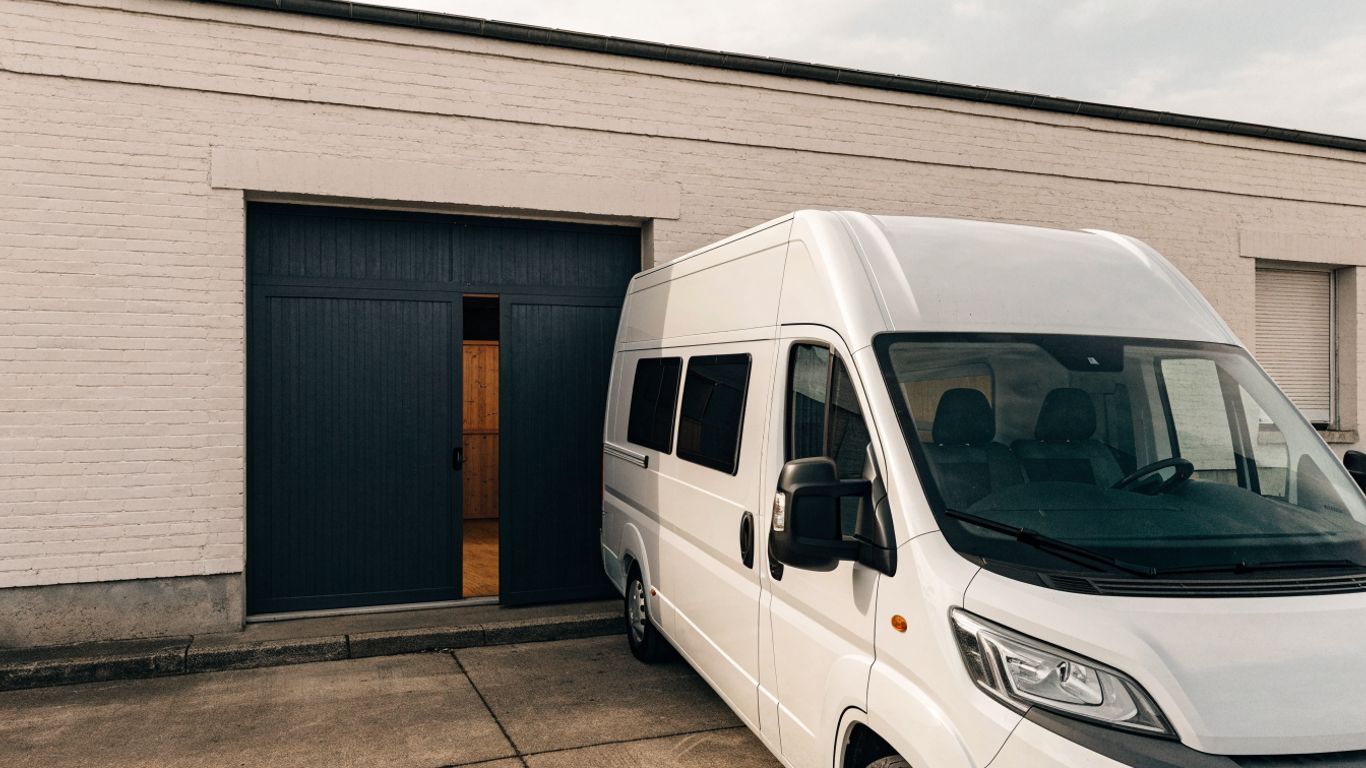 Fiat Ducato motorhome parked beside a workshop