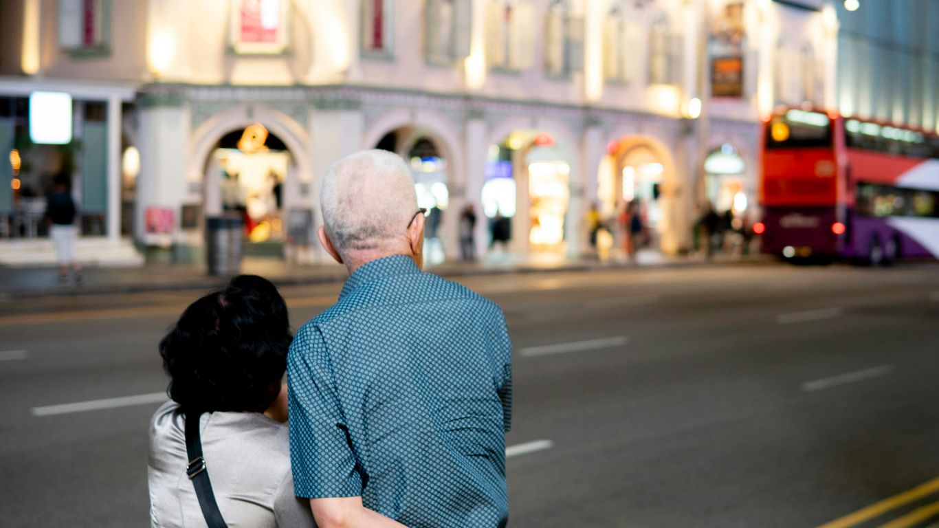 A man and a woman walking down a street