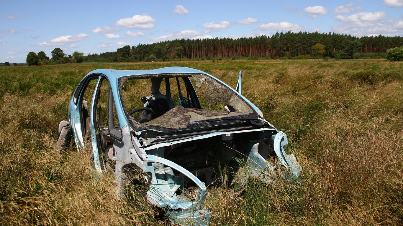 A car that is sitting in the grass