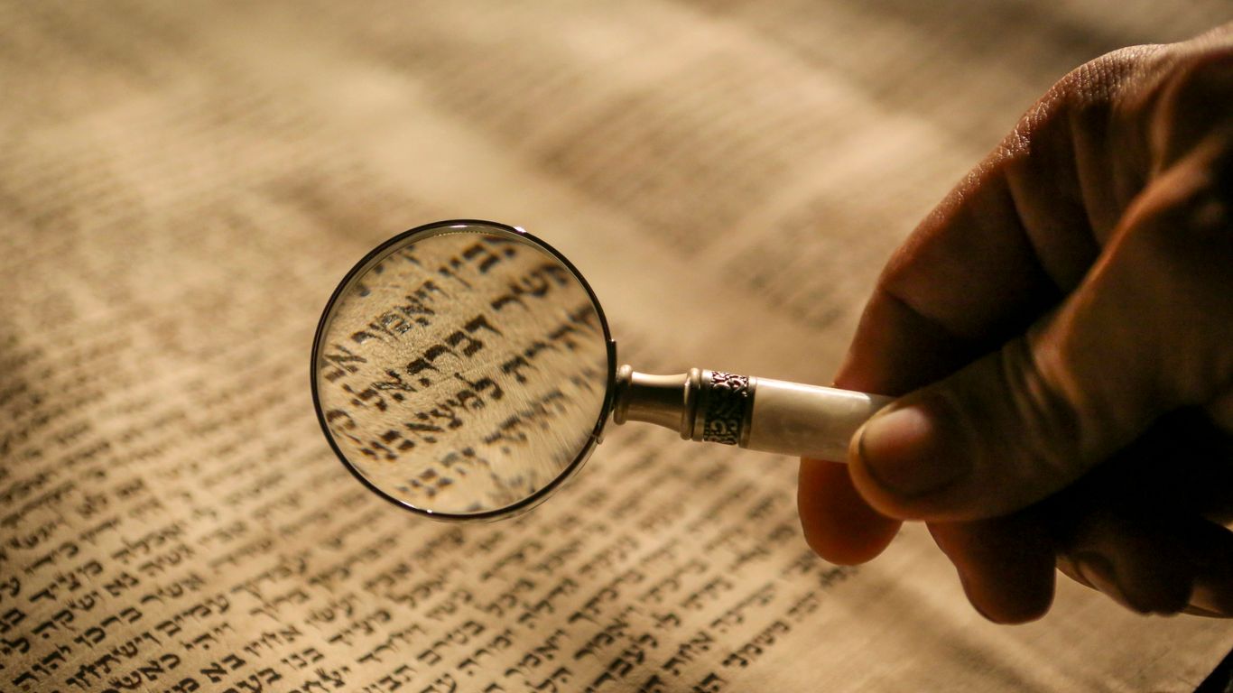 person holding magnifying glass