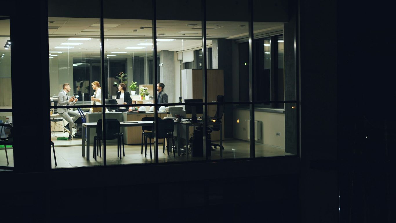 People working late in a modern office at night