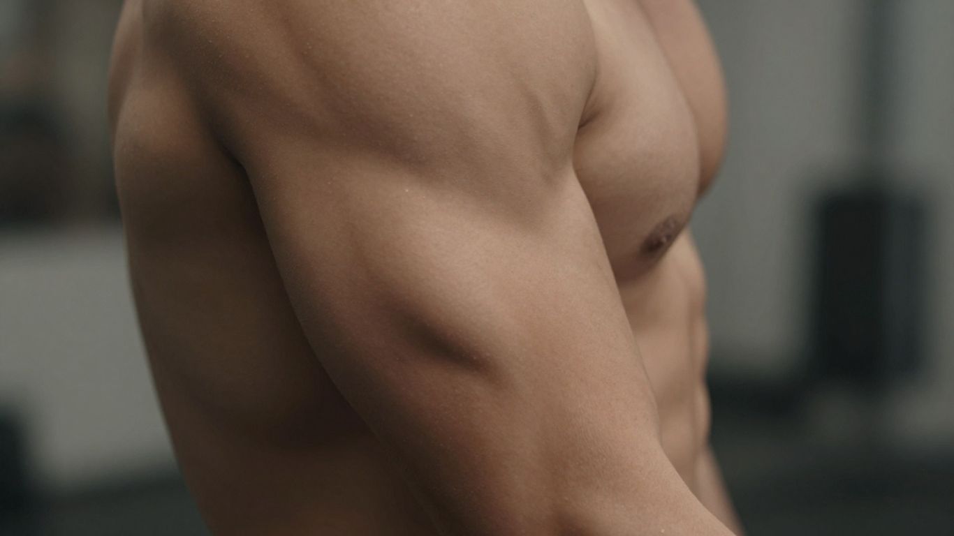 Muscular arm, peak physical condition, health focus.