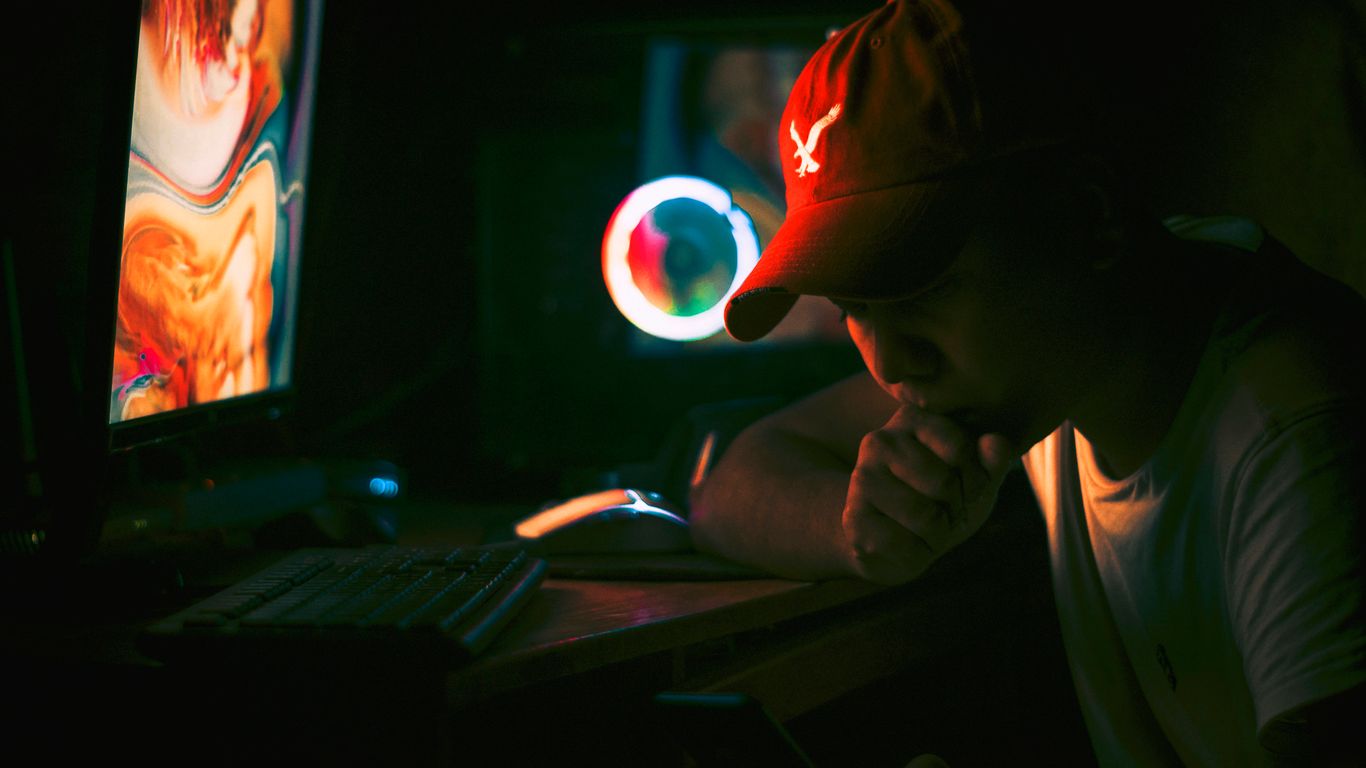 a man sitting at a desk in front of a computer