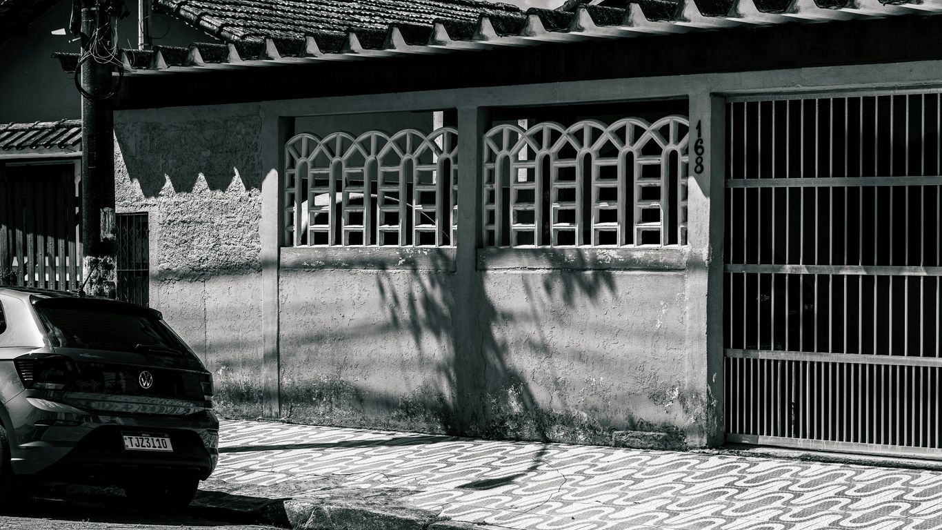 A car parked in front of a house entrance.