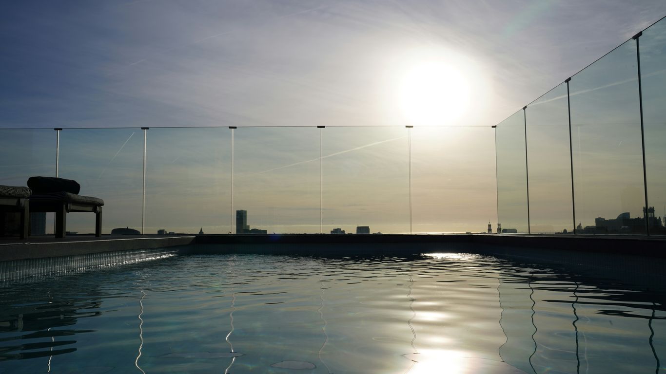 Rooftop pool overlooking the ocean at sunset