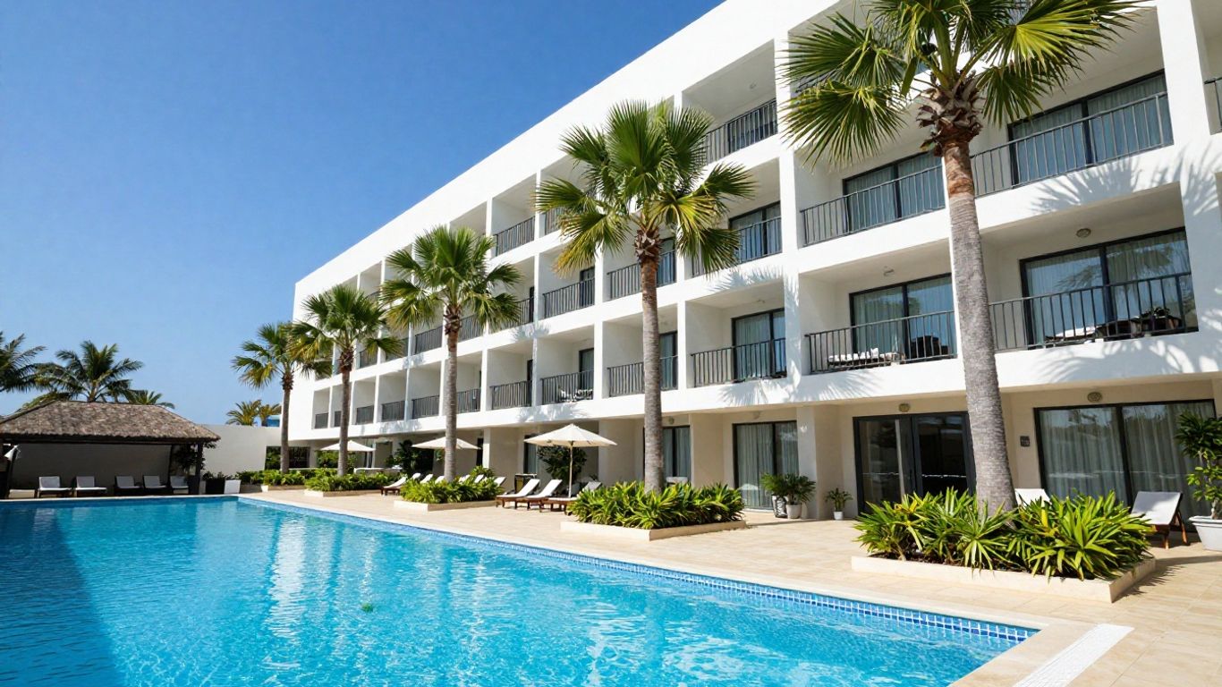 Oaks Mackay hotel exterior with pool and palm trees.