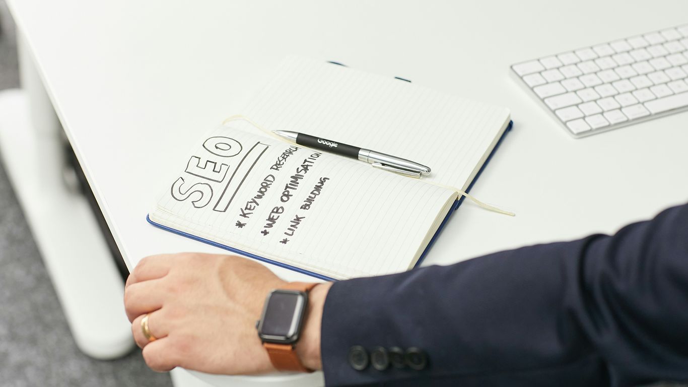 a person writing on a piece of paper