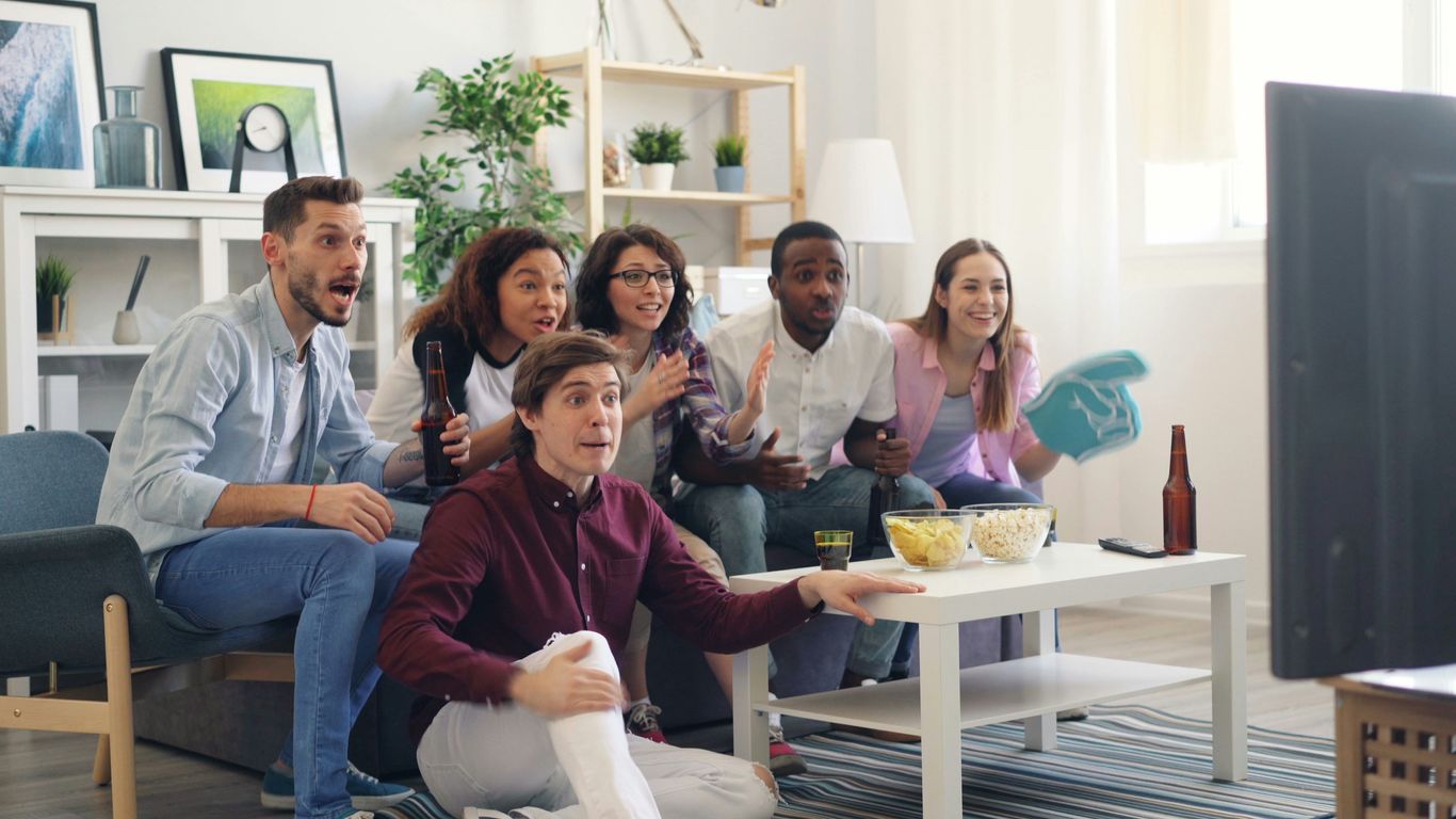 a group of people sitting on a couch in a living room