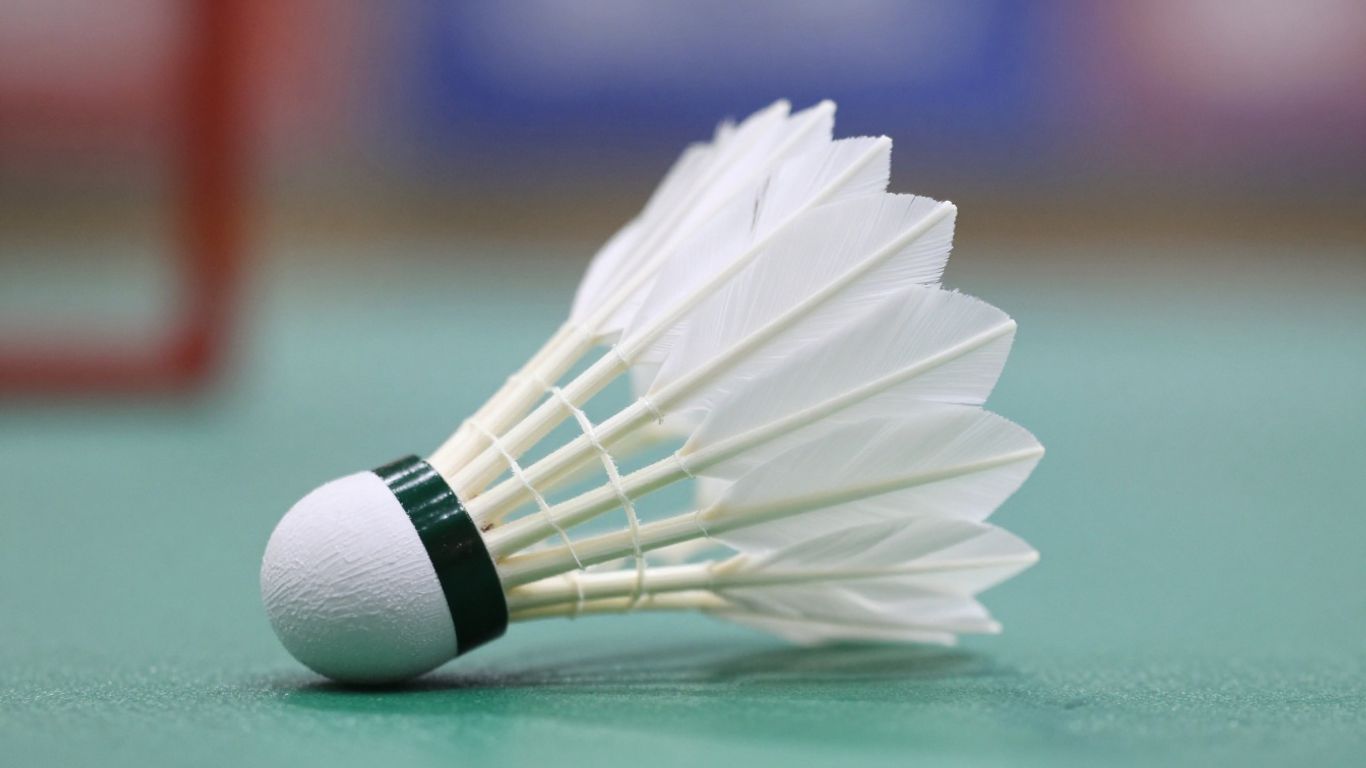 Close-up of a badminton shuttlecock in flight.