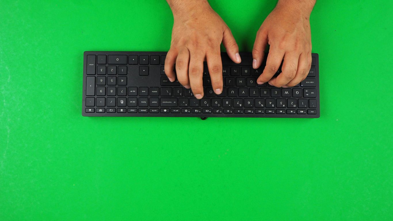 person typing on black keyboard