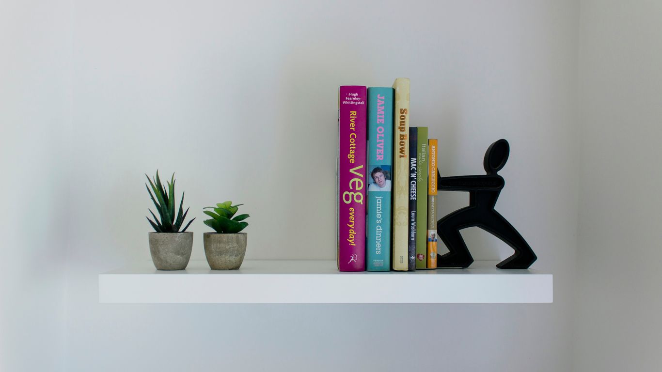 books on white wooden shelf