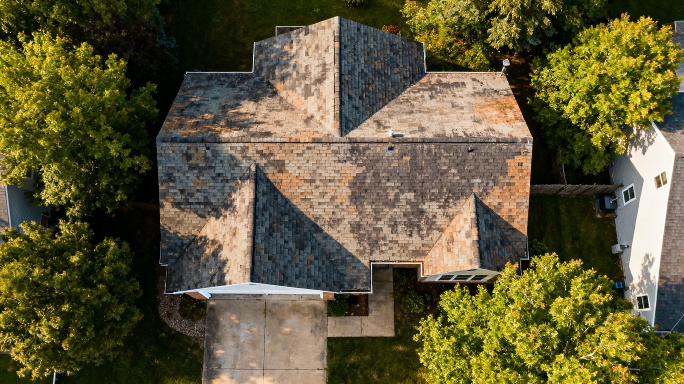 Drone view of aging roof and home