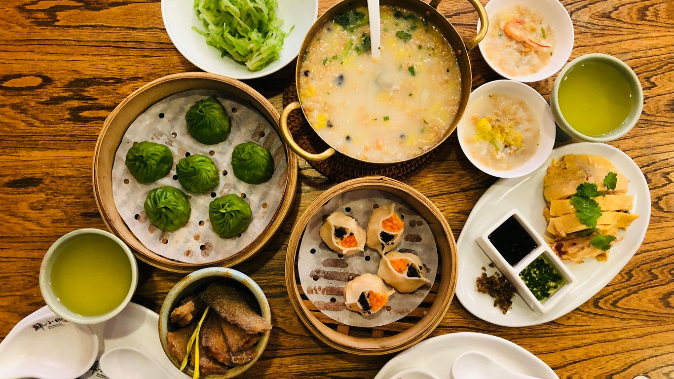 a wooden table topped with bowls of food