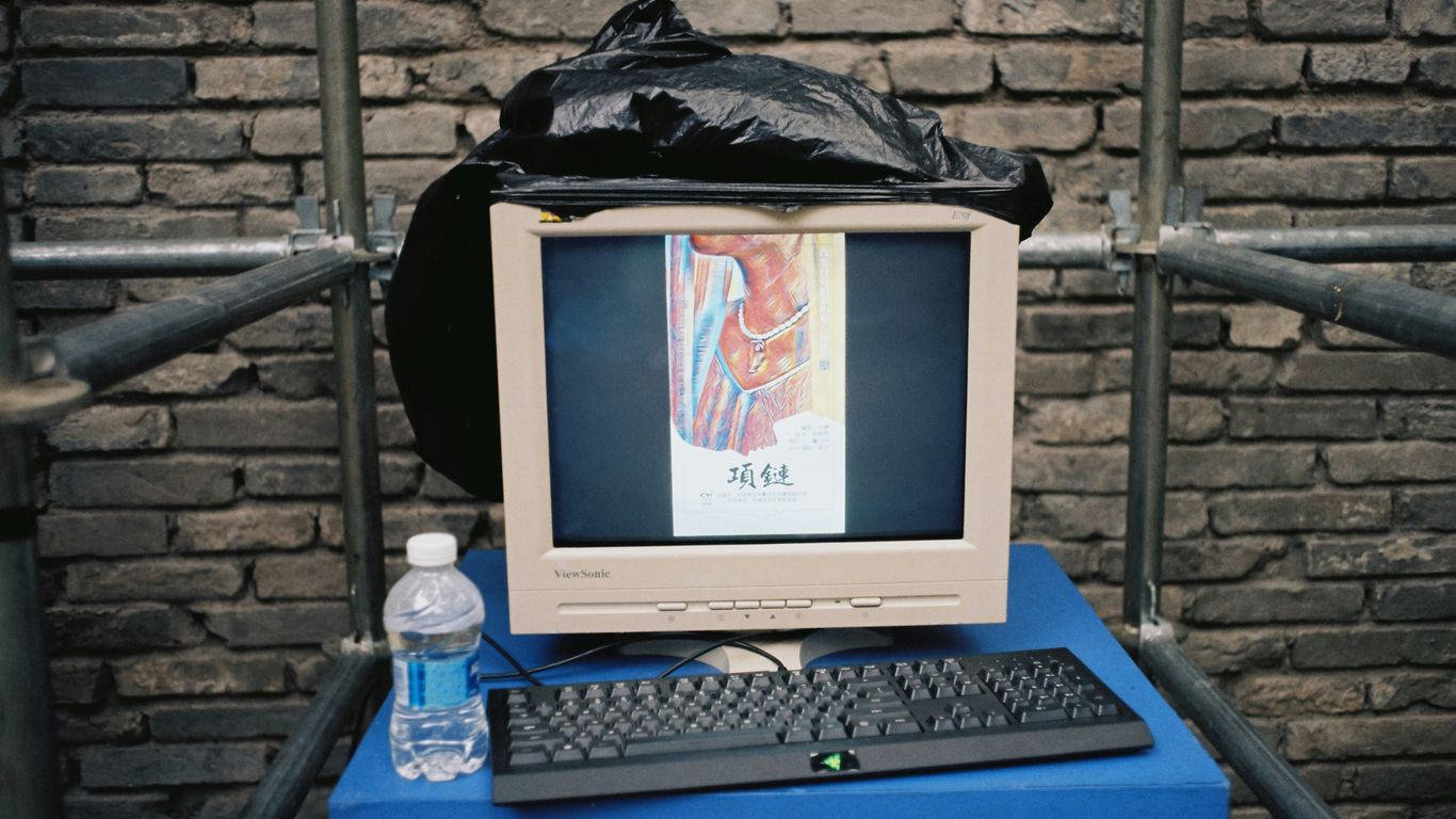 white crt computer monitor on blue table