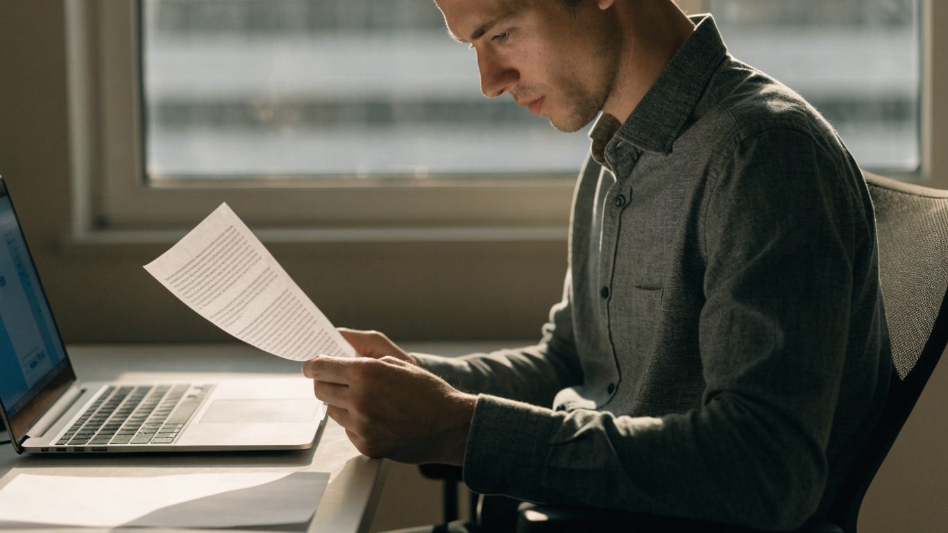 Trader reviewing futures evaluation rules at desk