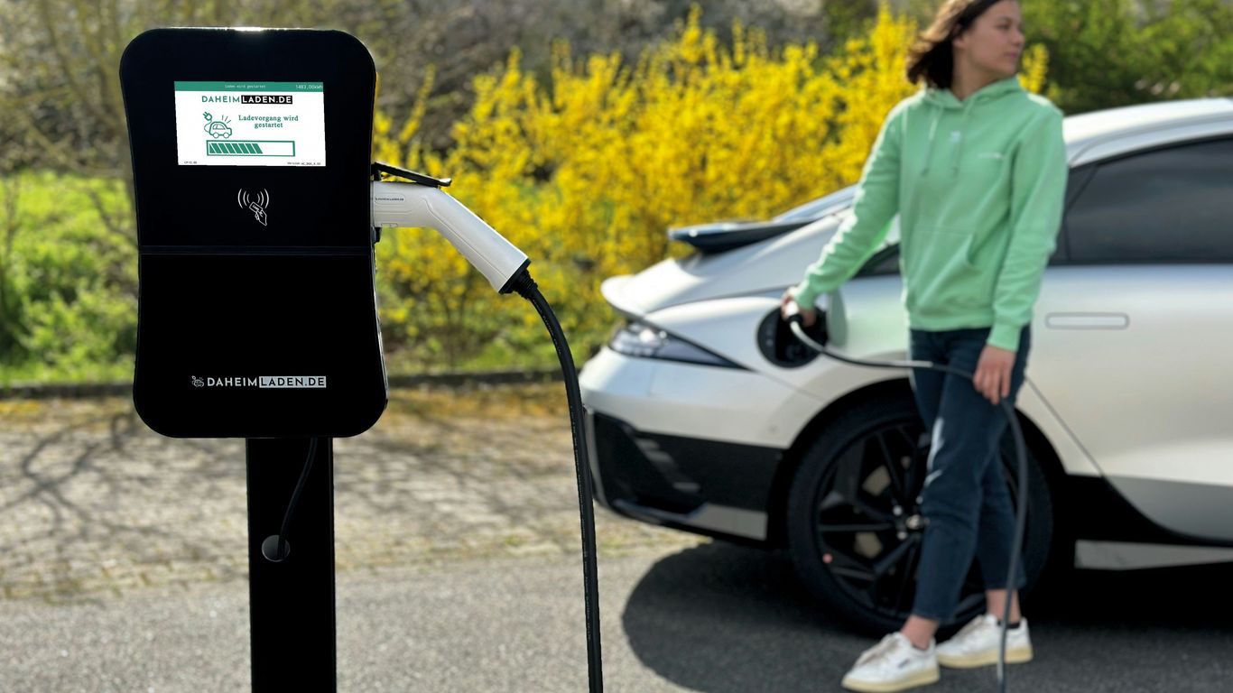a woman standing next to a white car