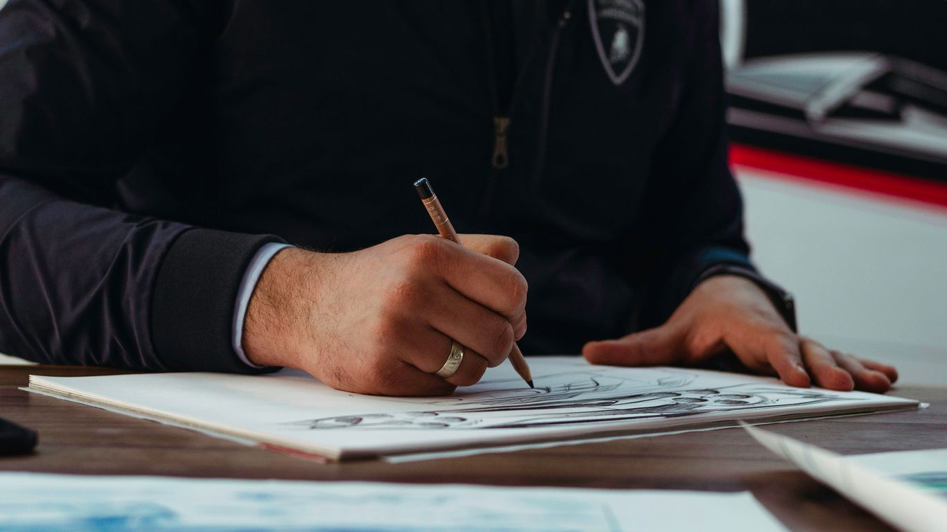 man writing on paper