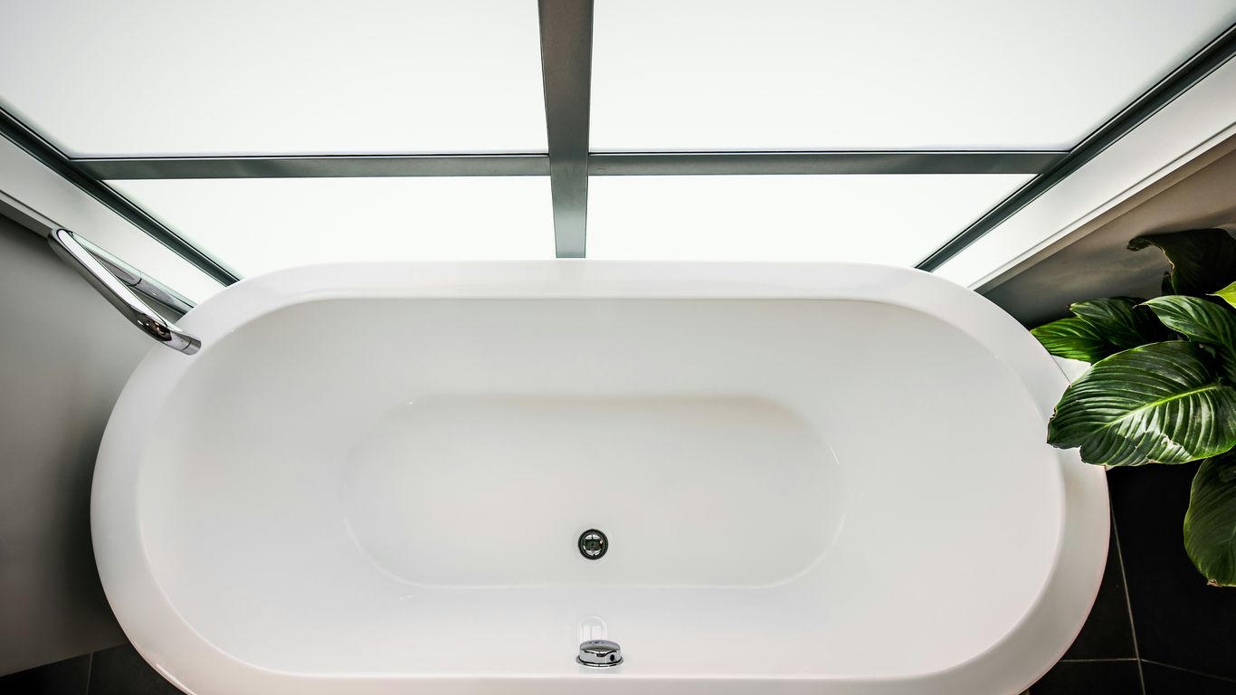 Filled stone bathtub with warm water